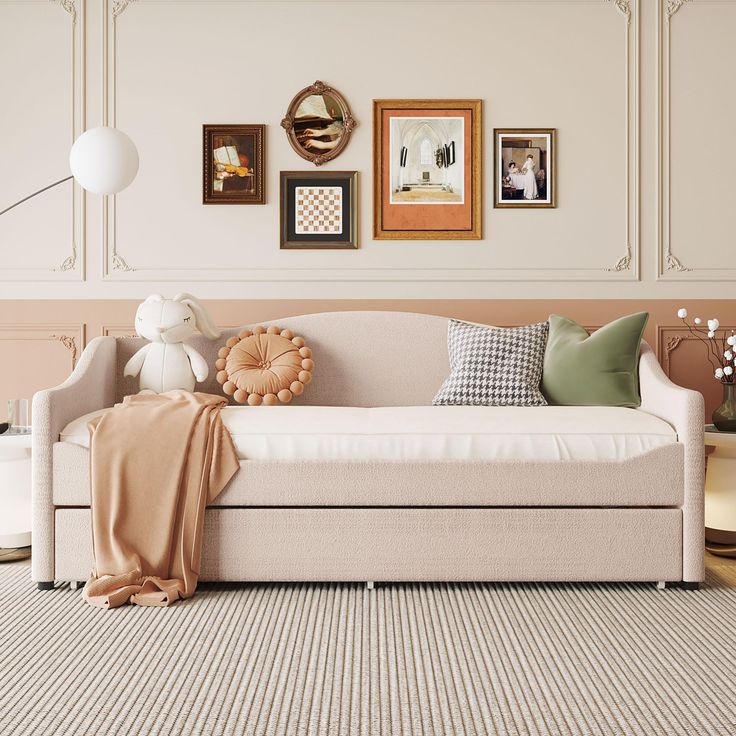 a living room filled with furniture and framed pictures on the wall above it's couch