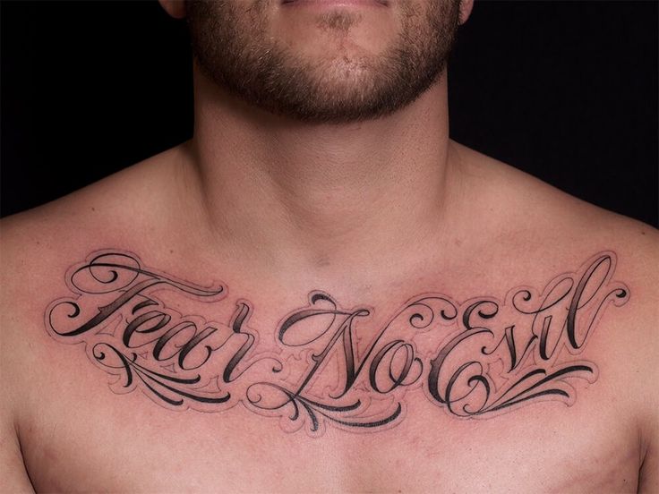 a man with a chest tattoo that says teal no evil