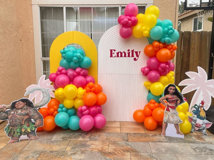 an entrance decorated with balloons and paper cut outs