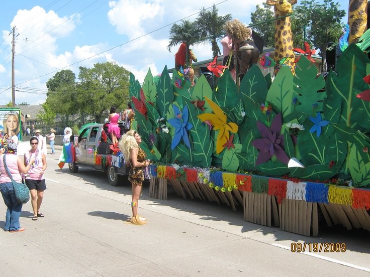 people are walking down the street in front of a float