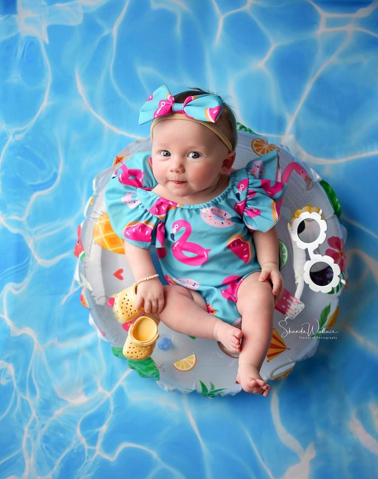 a baby sitting on top of an inflatable pool