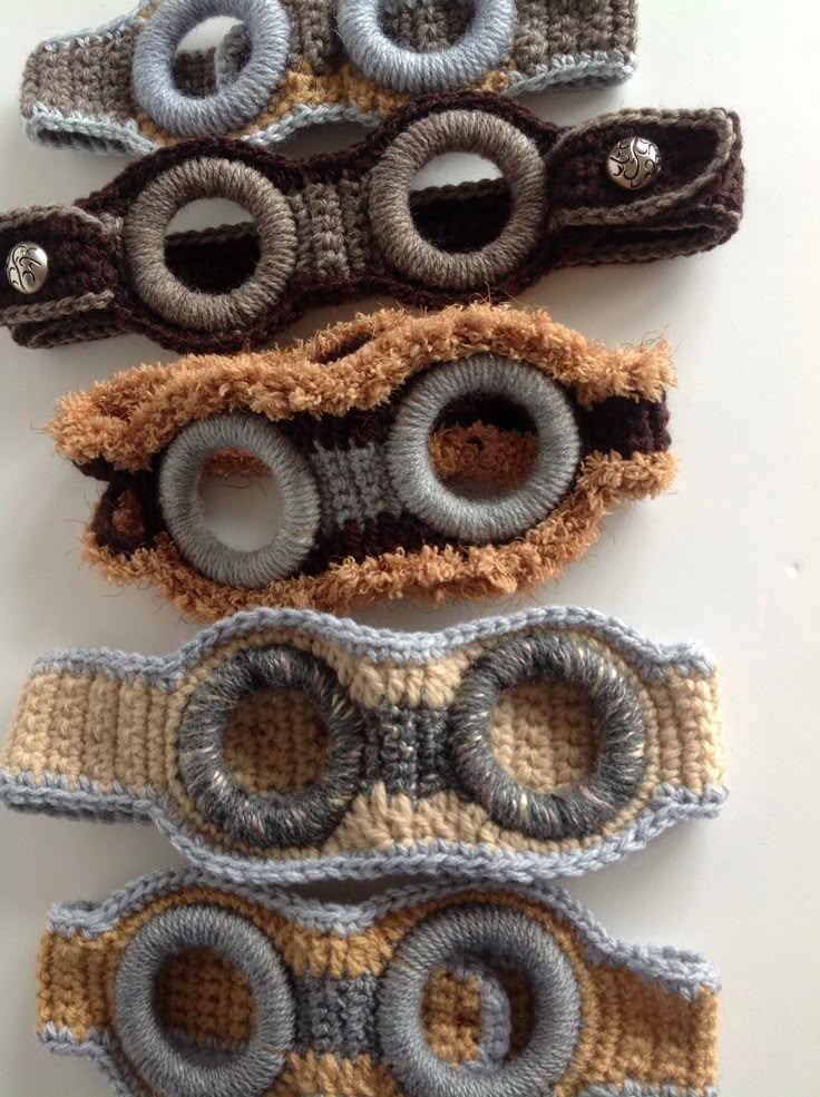 four crocheted eyeglasses are lined up on top of each other