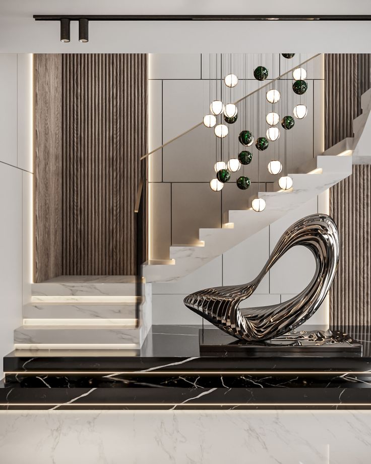 a modern staircase with marble steps leading up to the second floor and chandelier above it