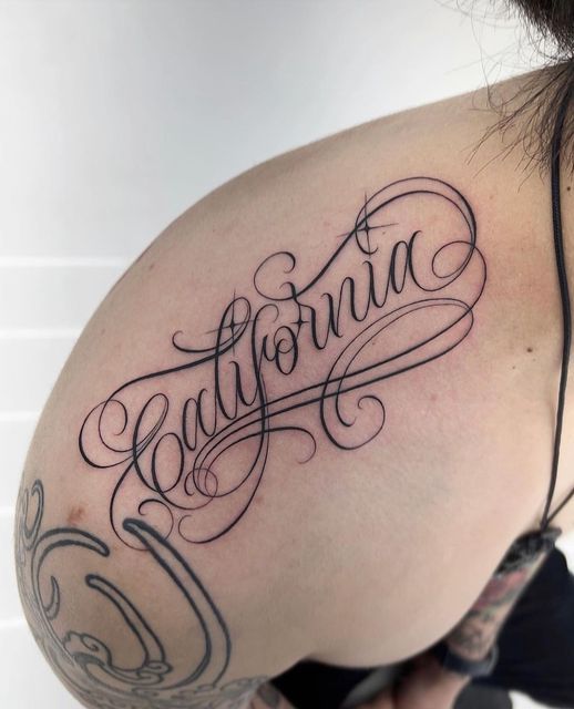 a woman's shoulder with the word california written in cursive writing