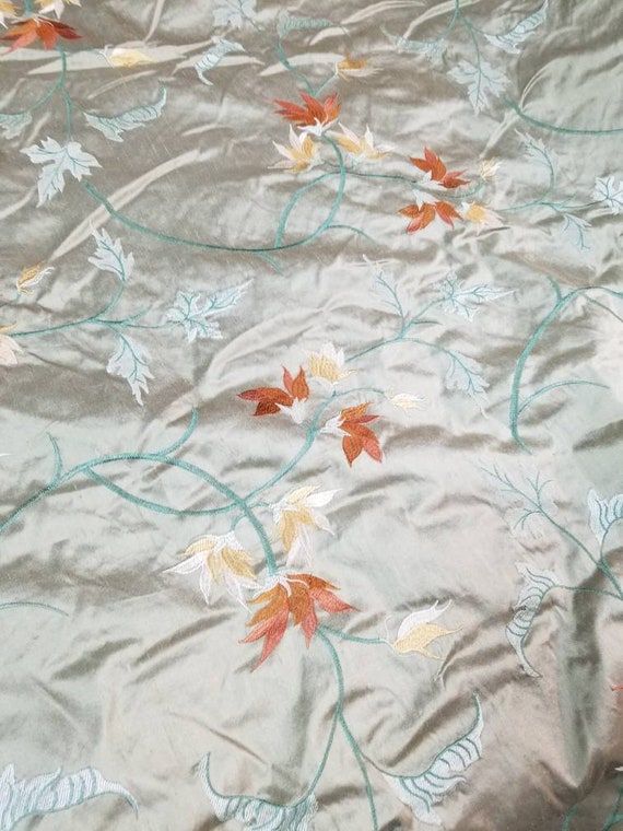 an image of a table cloth with leaves on it