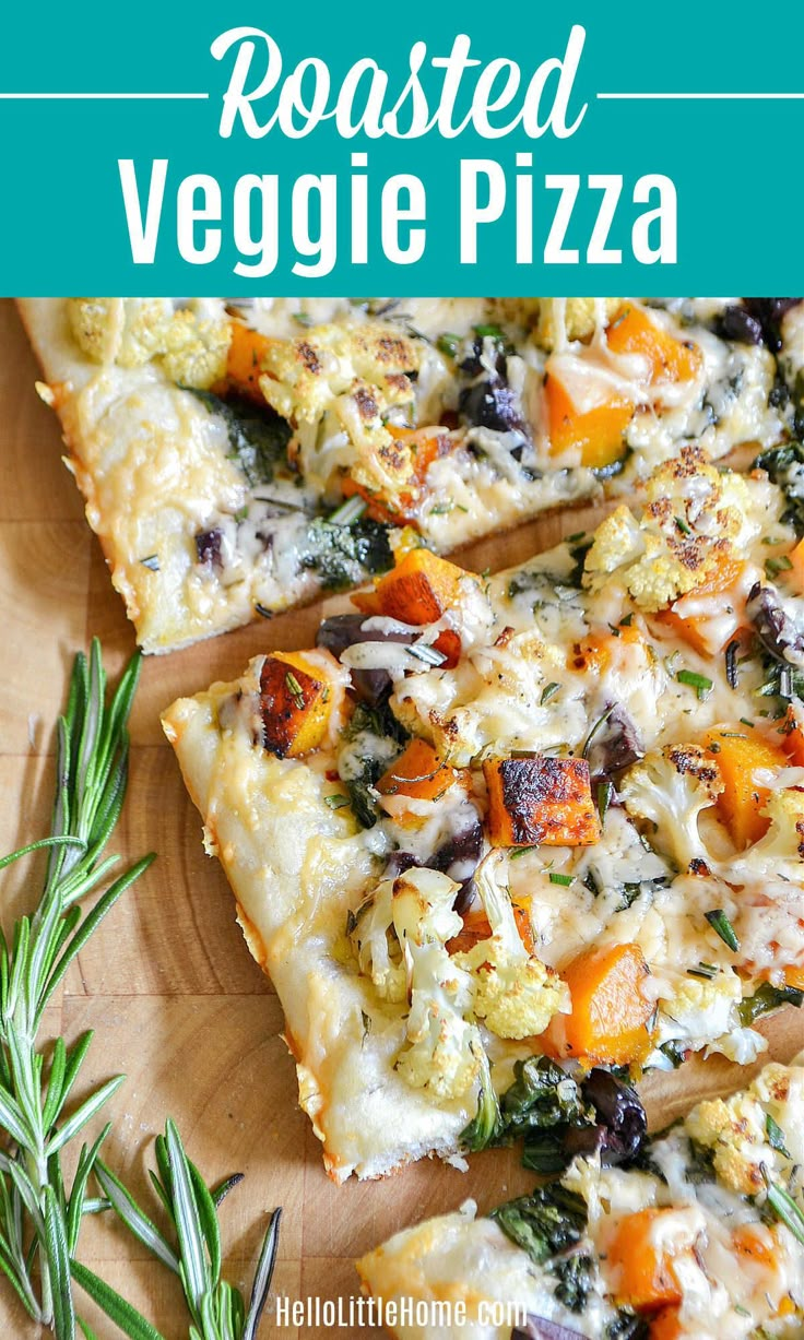 roasted veggie pizza on a cutting board with rosemary sprigs