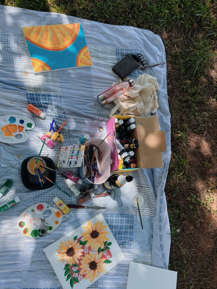 the table is covered with art supplies on it