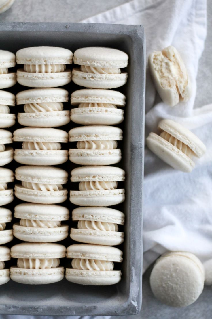 a baking pan filled with white cookies on top of a table