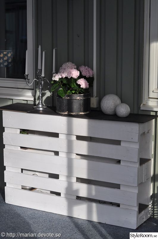 a white table with flowers and candles on it in front of a window sill