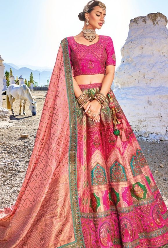 Crafted with the finest Banarasi Silk, luxurious jacquard and elegant satin, this lehenga is the ultimate embodiment of opulence and grace. LEHENGA FABRIC: Banaras Silk Jacquard BLOUSE FABRIC: Satin DUPATTA: Pure Georgette Viscose SIZING: Can be stitched upto 42 inches bust and waist SHIPPING: The product will be shipped within 1 - 2 weeks from the date of purchase. Stitched item will ship within 2-3 weeks from the date of the order All stitched products are final sale. We will contact you withi Banarsi Silk Lehenga, Umbrella Lehenga, Bridesmaid Lehenga, Silk Lehenga Choli, Groom Wedding Attire, Rani Pink, Maroon Wedding, Jacquard Blouse, Lehenga Online