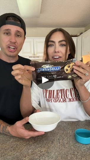 the man and woman are holding up their food in front of them while they look surprised