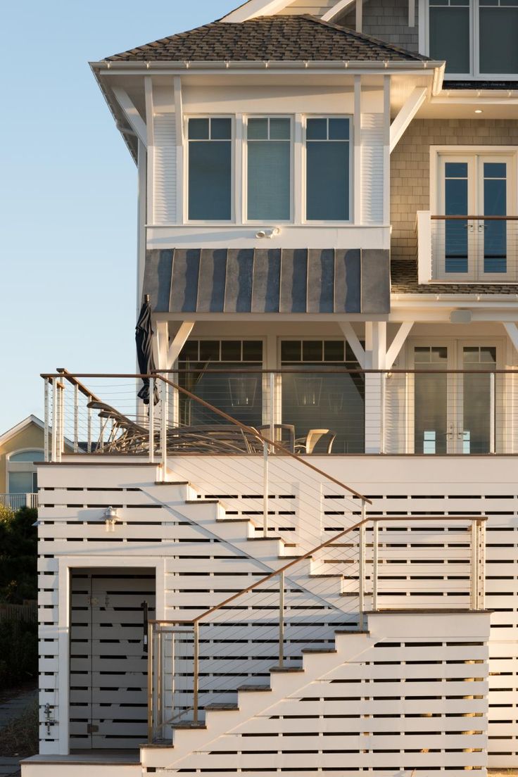 a large white house with stairs leading up to it