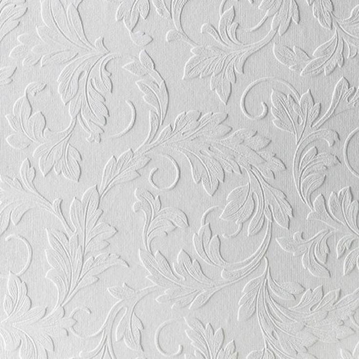 white wallpaper with an intricate design on it's surface and the background is painted in