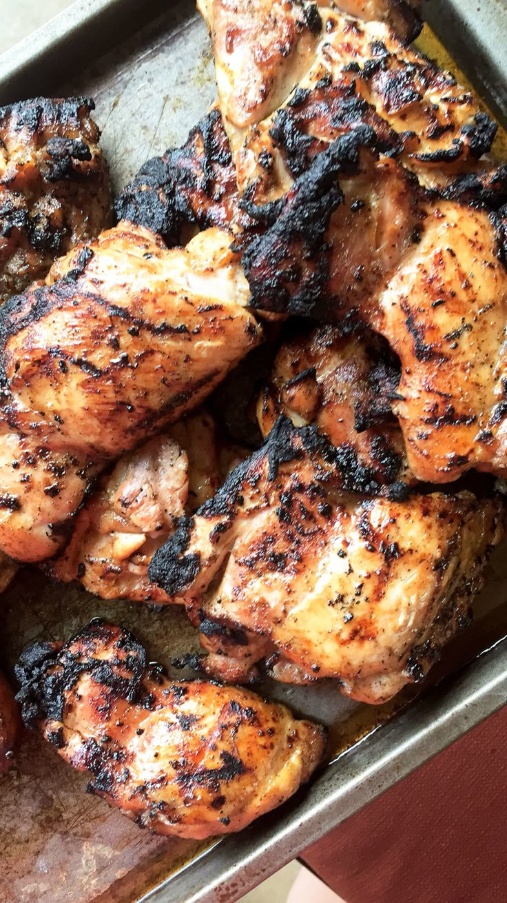 grilled chicken and carrots in a pan on a table