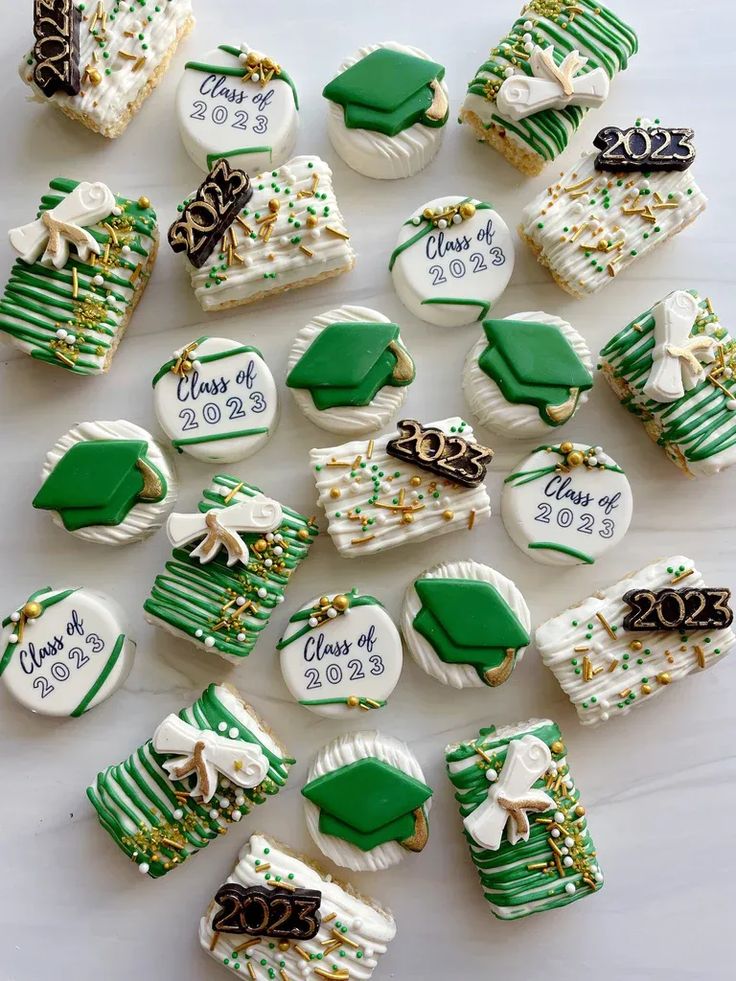 decorated cookies are arranged on a white tablecloth with green and gold trimmings