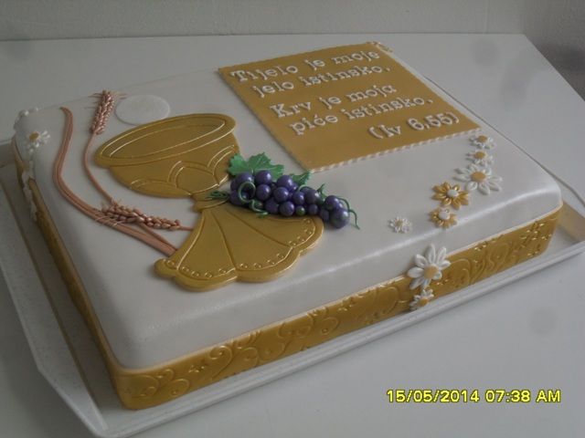 a cake that has been decorated with grapes and a crucifix on it