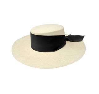 a white hat with a black ribbon around the brim