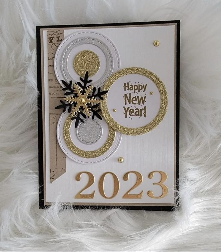 a white and gold new year's card with a snowflake on it