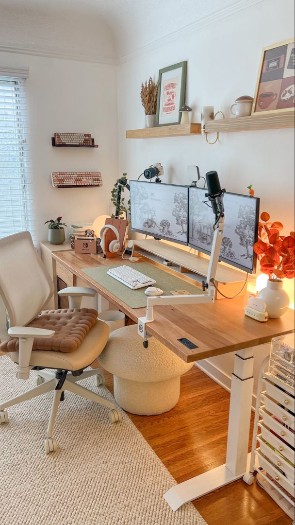 a home office with two computer screens on the wall and a chair in front of it