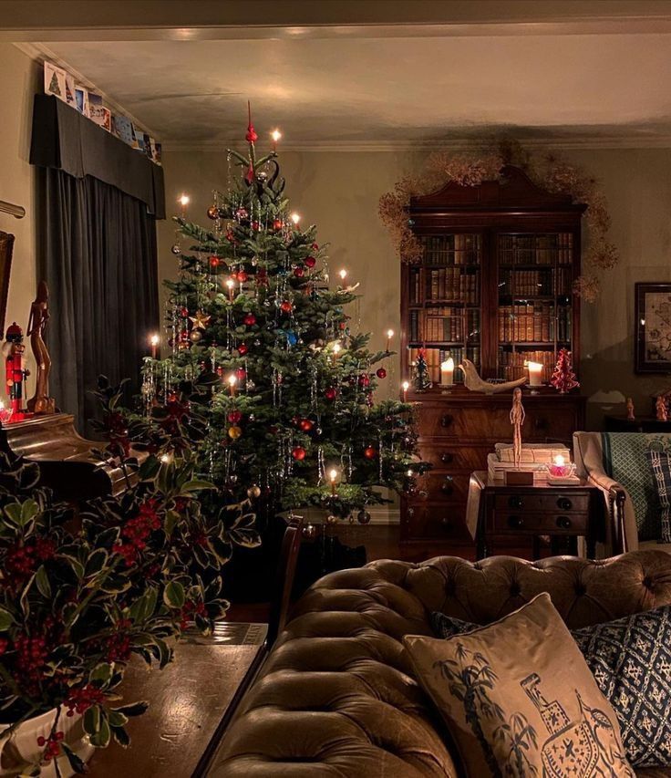 a living room filled with furniture and a christmas tree in the middle of the room