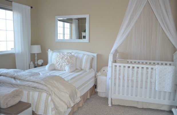 a baby's room with a crib, bed and dresser