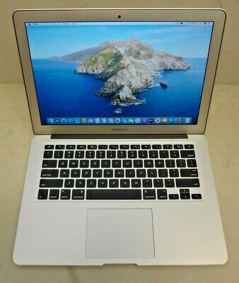 an open laptop computer sitting on top of a white table