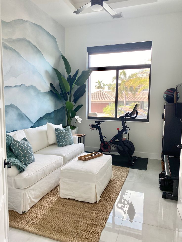 a living room filled with furniture and a painting on the wall