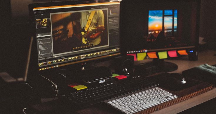 two computer monitors sitting next to each other on a desk