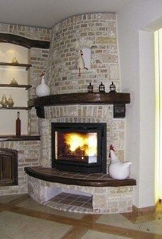 a living room with a stone fireplace and shelves