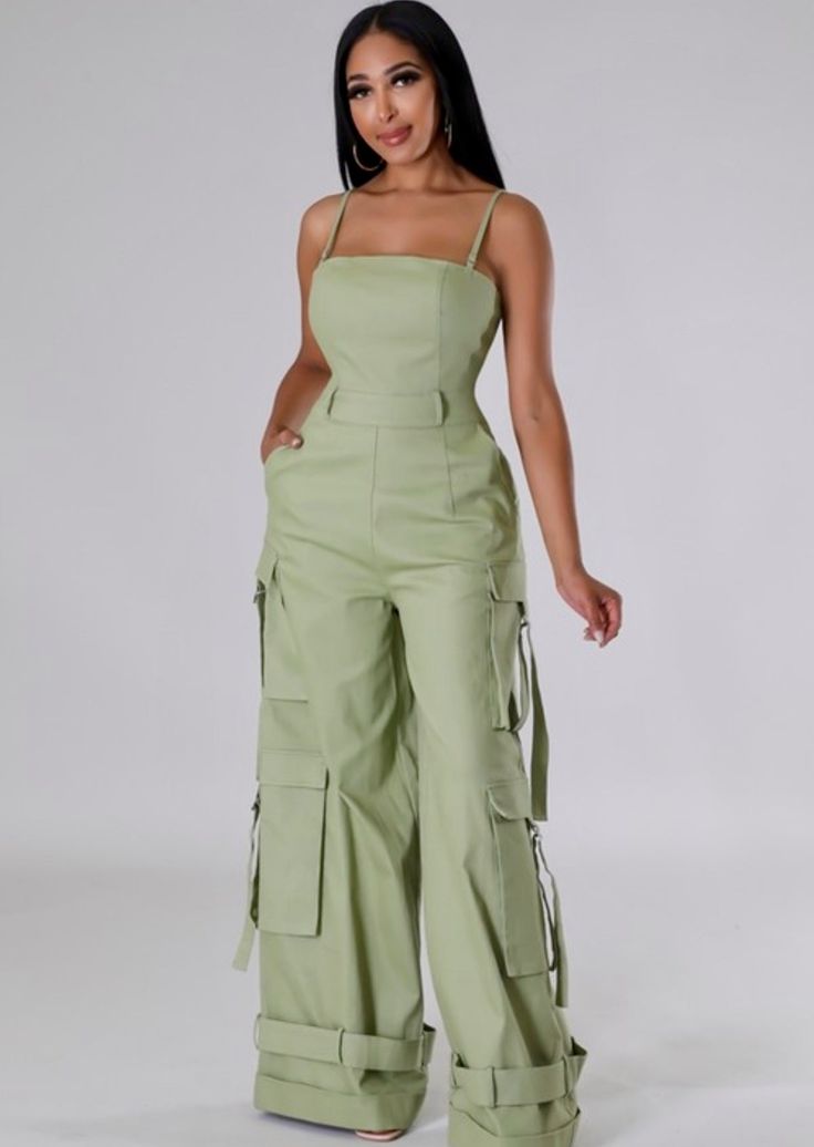 The Jocelyn Jumpsuit screams style. This on-trend wide leg cut cargo jumpsuit features adjustable spaghetti straps, belt loops, side pockets and the perfect amount of stretch. Style it with a bodysuit/cropped jacket for more coverage/a different vibe. Inseam: 34 inches Color: Light Olive Model is 5 ft 8 in tall and wearing heels If you are top heavy and in between sizes, go up a size. Sizes: L fits sizes 10/12 - as shown on our owner, Tamika (size 10/12) Cargo Jumpsuit, 2piece Outfits, Mode Kimono, Chic Dress Classy, Kids Dress Wear, Fashion Top Outfits, Jumpsuit Elegant, Beachwear Fashion, Ankara Dress