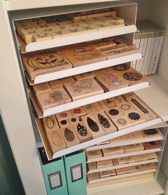 several wooden boxes are stacked on top of each other in a bookcase with drawers