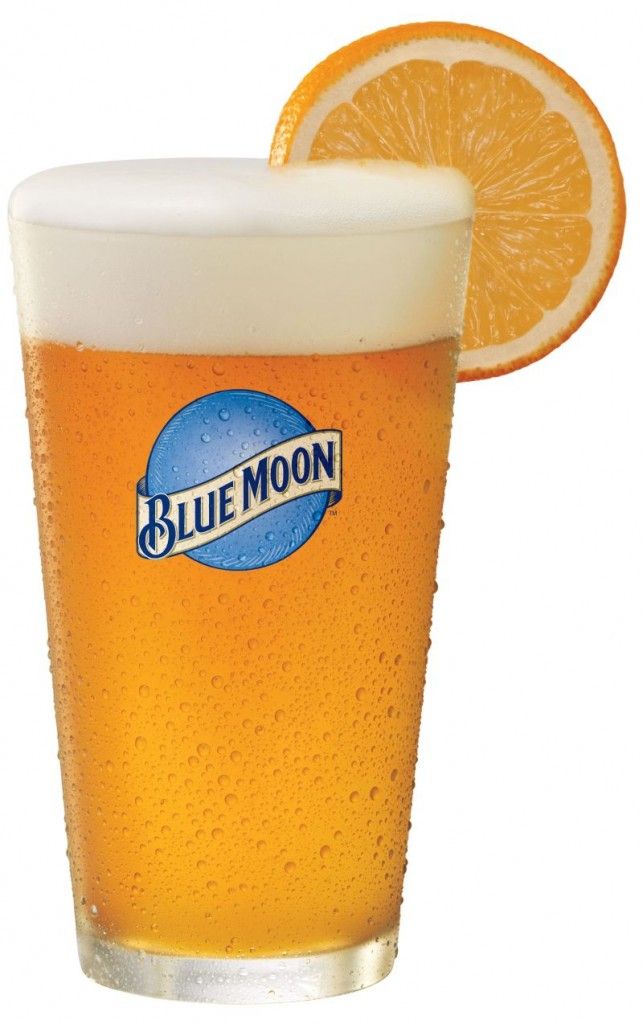 a glass of beer with an orange slice on the rim and blue moon in the bottom