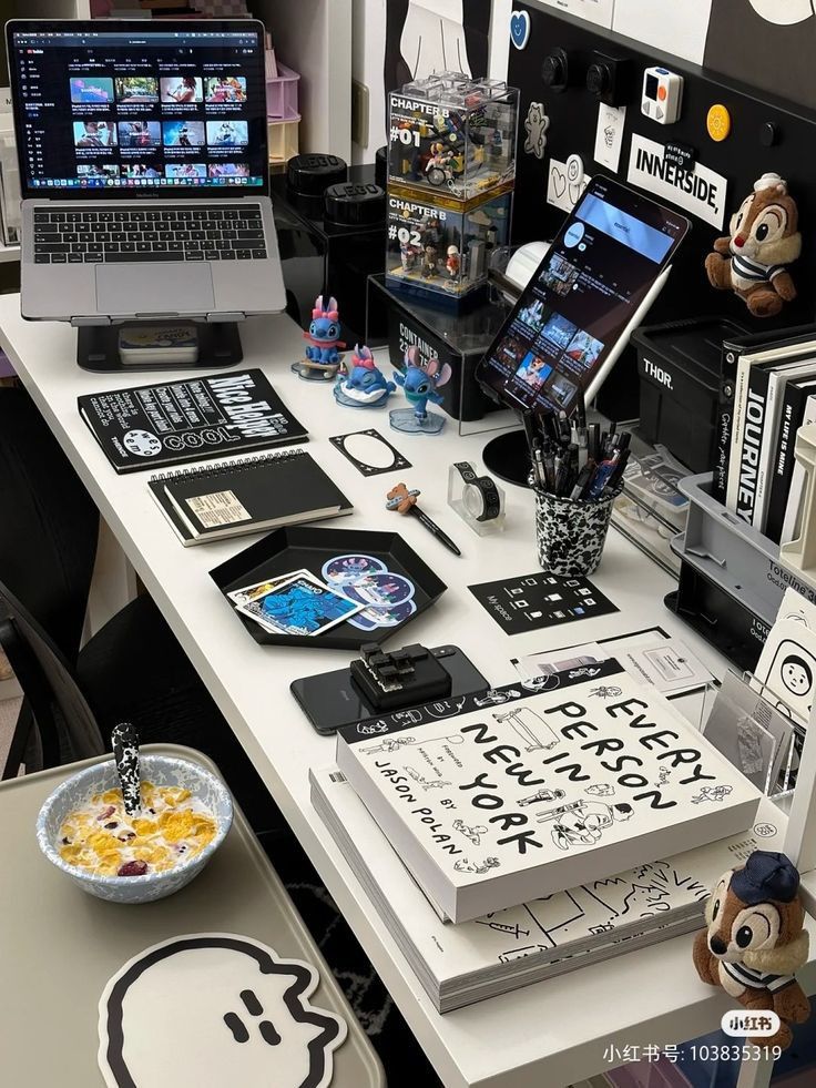 there is a desk with many items on it, including cell phones and laptops