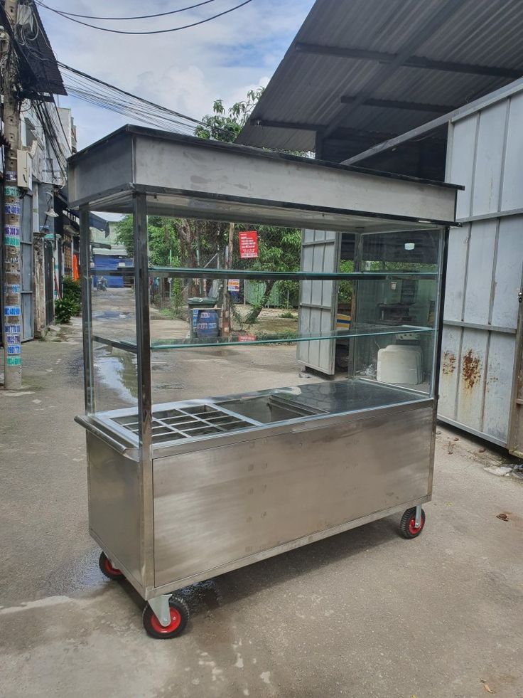 an outdoor food cart sitting in front of a building