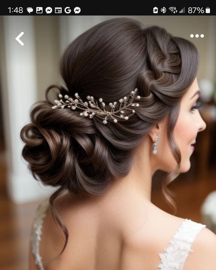 a woman wearing a wedding hair comb with pearls on it's head and her hair pinned into a low bun