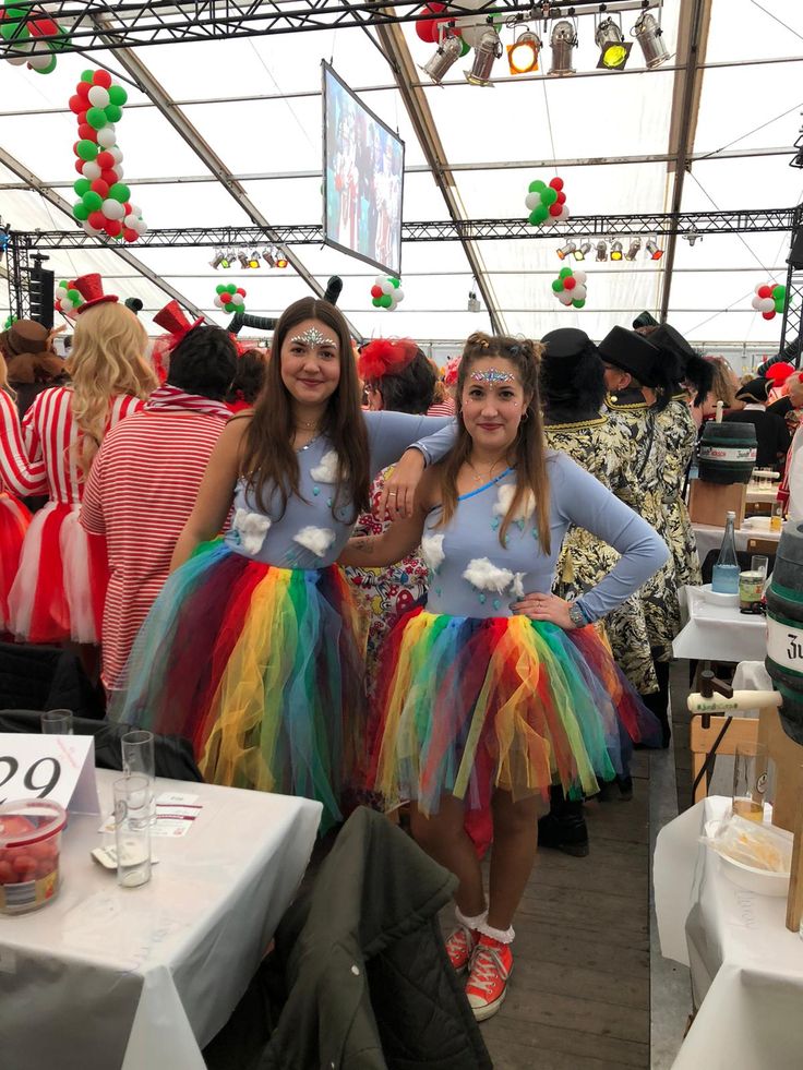 two girls dressed in costumes standing next to each other