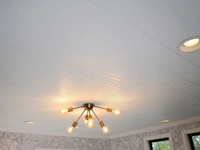 a bedroom with marble walls and ceiling lights