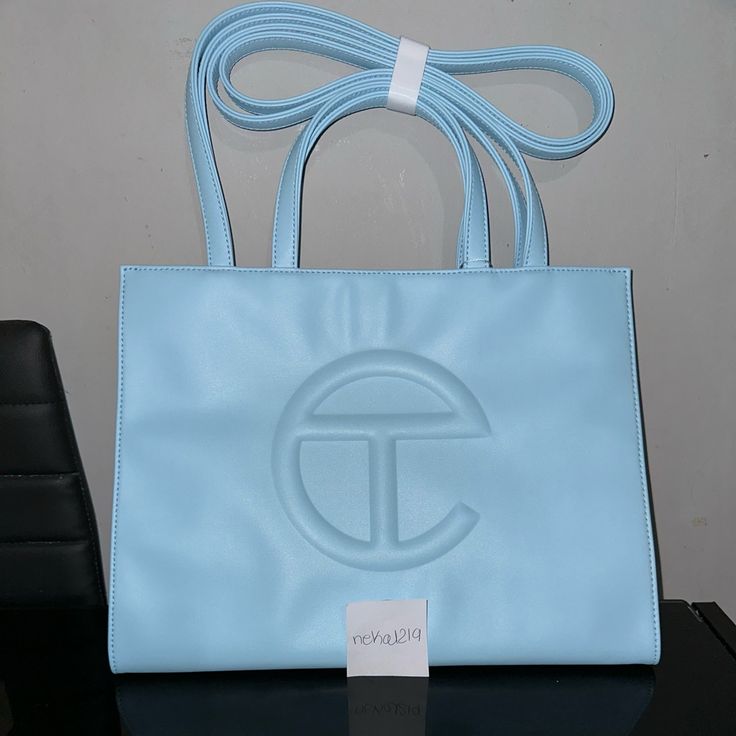 Telfar Shopping Bag Brand New Medium Pool Blue Shopping Bag Comes With Dust Bag Sold Out Price Is Firm No Free Shipping #Palmangels #Telfar #Bag #Hat #Shirt Designer Blue Satchel With Large Capacity, Luxury Blue Box Bag For Errands, Designer Blue Bag With Double Handle, Blue Shopping Bag With Top Carry Handle, Top Handle Tan Bag For Shopping, Tan Top Handle Bag For Shopping, Tan Top Handle Shopping Bag, Light Blue Pouch Shoulder Bag For Shopping, Light Blue Bag With Removable Pouch For Errands