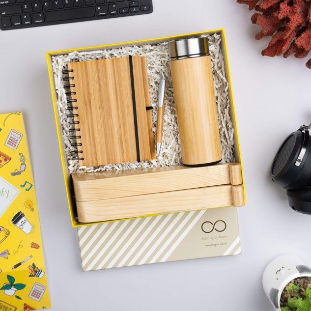 an open box with two wooden items on top of it next to a keyboard and other office supplies