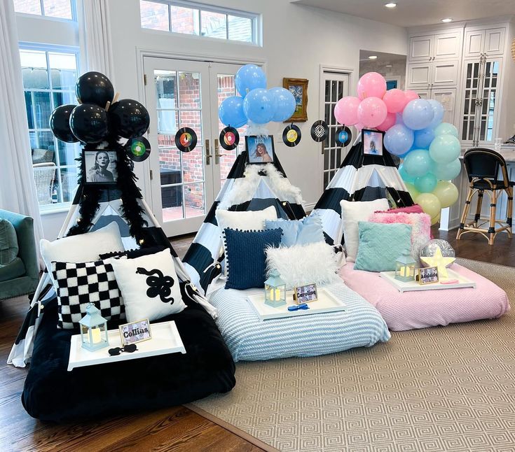 a living room filled with lots of furniture and balloons