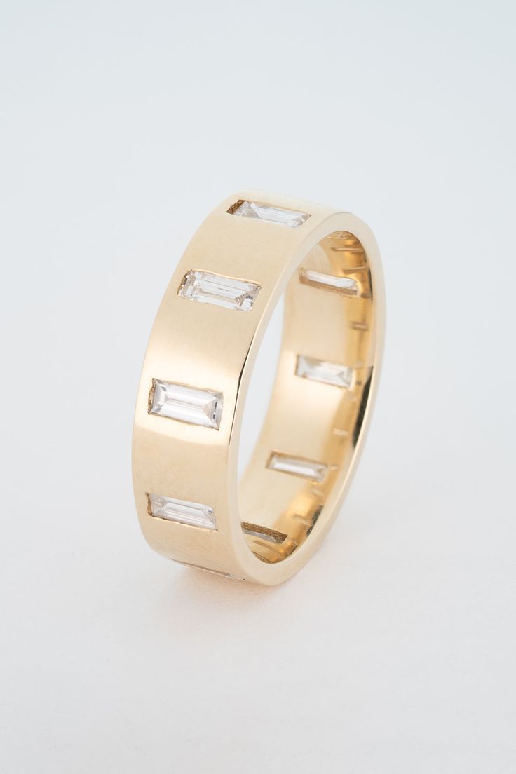 The North South Gypsy Baguette Band is a personal favorite of mine. The band is composed of 10 North-South facing gypsy set Baguette Diamonds. The band is made as an eternity style, meaning diamonds wrap around the entire exterior of the band. It's perfect on its own, or will sit beautifully with any STVDIO Engagement ring, or stacking situation. Our Baguette pieces are made with Recycled Diamonds, and all diamonds are G-H Color, and VS Clarity. Bands can be matched to a center stone color and c Baguette Band, Modern Wedding Band, North South, 3 Carat, Emerald Engagement Ring, Baguette Diamond, Gold Wedding Band, Ring Verlobung, Wedding Bands