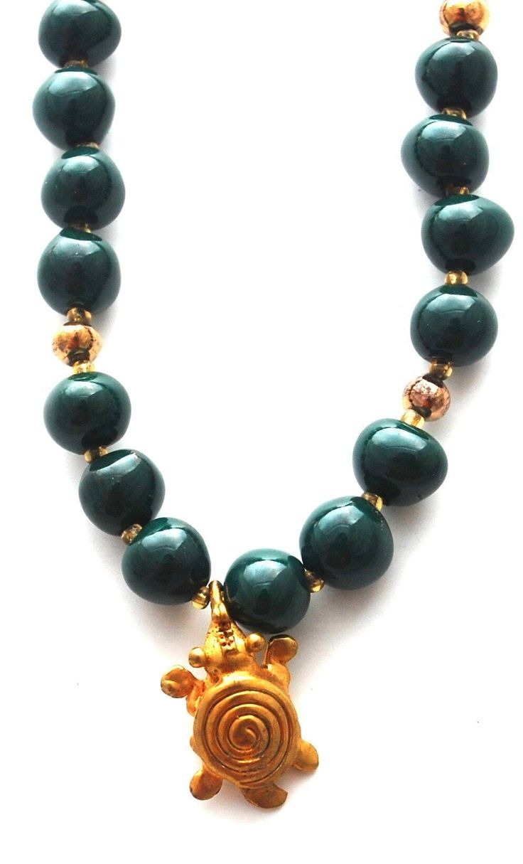 "24k gold plated turtle pendant hangs from our 20 inch green beaded necklace. Handcrafted glazed clay beads with 24k gold accent beads. Beautiful deep \"malachite\", perfect for holiday giving. In many cultures, the turtle symbolizes wisdom and patience.  Handmade in Costa Rica." Handmade Gold Jade Beaded Necklaces, Gold Jade Necklaces With Round Beads, Spiritual Gold Jade Beaded Necklaces, Spiritual Gold Jade Beaded Necklace, Gold Jade Beaded Necklaces With Round Beads, Gold Jade Round Beaded Necklaces, Gold Jade Necklaces With Polished Beads, Gold Spiritual Emerald Necklace With Round Beads, Gold Emerald Necklace With Round Beads And Spiritual Style