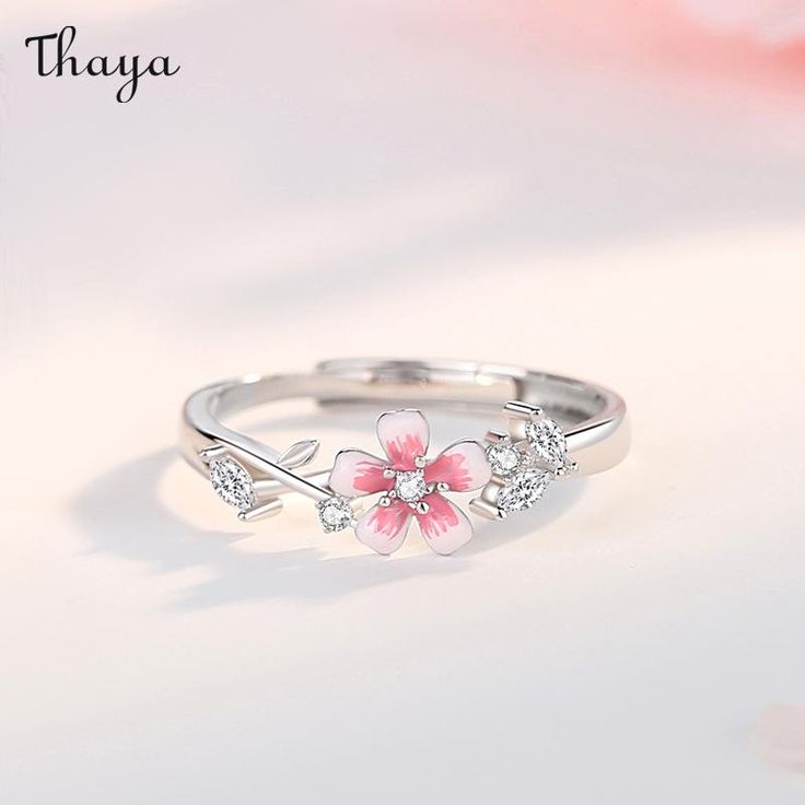 With the Sakura couple rings, celebrate your love in a traditional way. Inspired by the delicate pink blossoms and their symbolism of love and new beginnings, these rings represent a timeless promise between two hearts. Let your love bloom like the beautiful cherry blossoms.   - Brand: Thaya  - Material: S925 silver, synthetic cubic zirconia, enamel.  - Size: The widest part of the men's ring is 5.6 mm, and the widest part of the women's                   ring is 2.6 mm.  - Weight: Male 2.12g Female 1.76g  - Gender: Couple style    Open ring, adjustable, size for reference    Women's rings are suitable for the United States Size: 6-7, the inner diameter is about 16.5-17.3mm  Men's rings are suitable for US Size: 8-9, inner diameter is about 18.1-19mm Sakura Ring, Fantasy Wedding Rings, Cherry Blossom Ring, Promise Rings For Couples, Couple Style, Sakura Flower, Teardrop Ring, Hand Accessories, Women's Rings