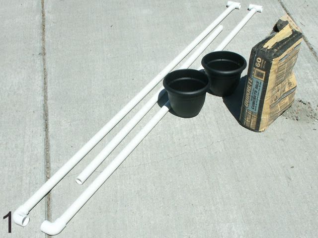 two black cups sitting on top of a cement floor next to a carton of milk