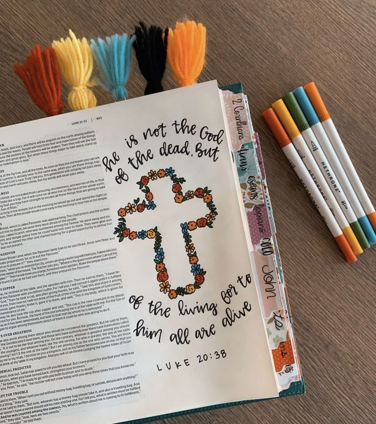 an open bible with colored crayons next to it