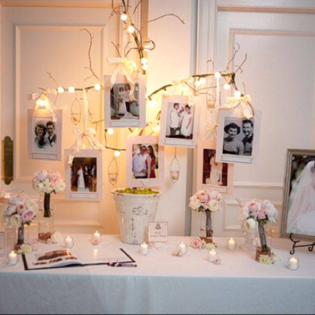 a white table topped with pictures and flowers