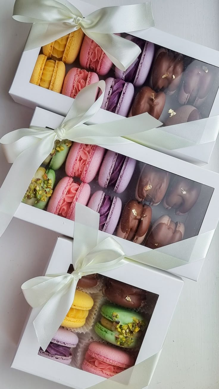 two boxes filled with different types of macaroons