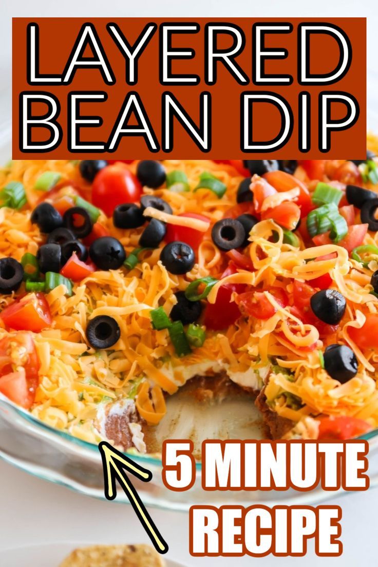 layered bean dip recipe with 5 minutes left to make it in the oven and ready to be eaten