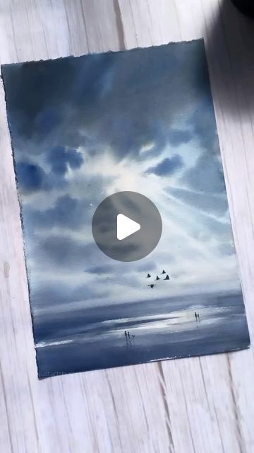 an image of birds flying in the sky on a wooden table with a video player