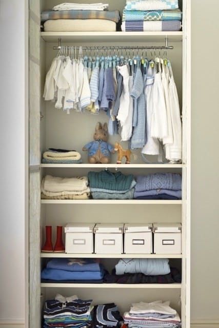 an organized closet with baby clothes and diapers